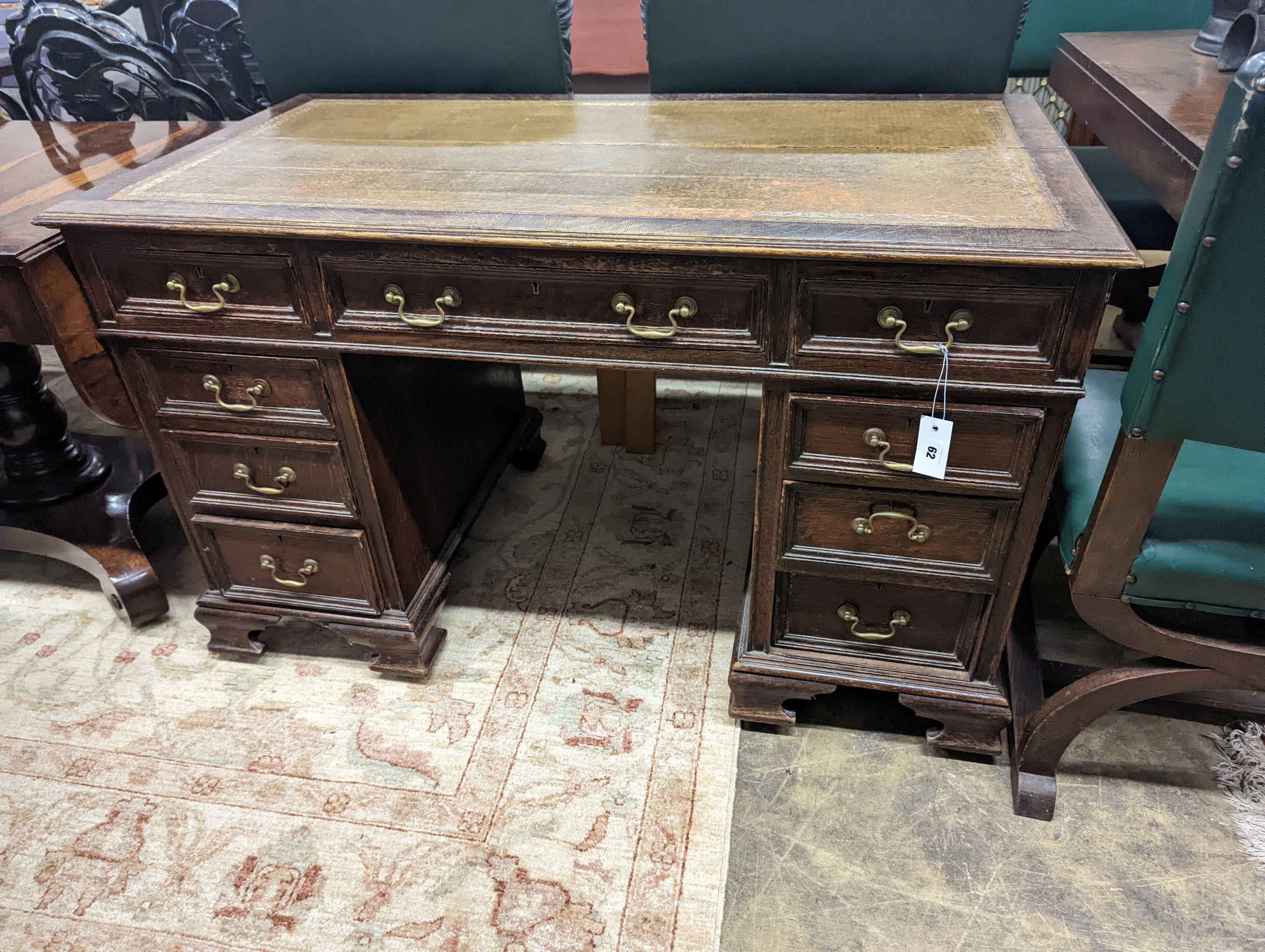 An early 20th century oak kneehole desk, length 122cm, depth 66cm, height 75cm